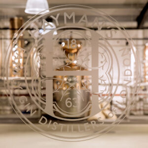 Hayman's distillery sign with stills behind